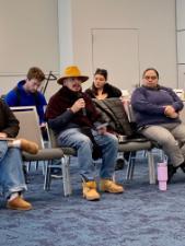 Latinx students eat pizza with Dr. Messer while discussing core values.